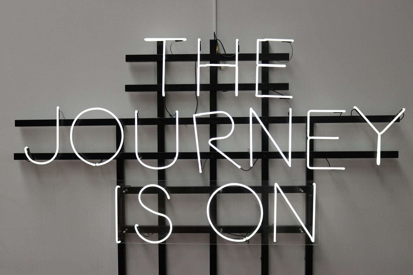 Neon sign reading The Journey Is On.