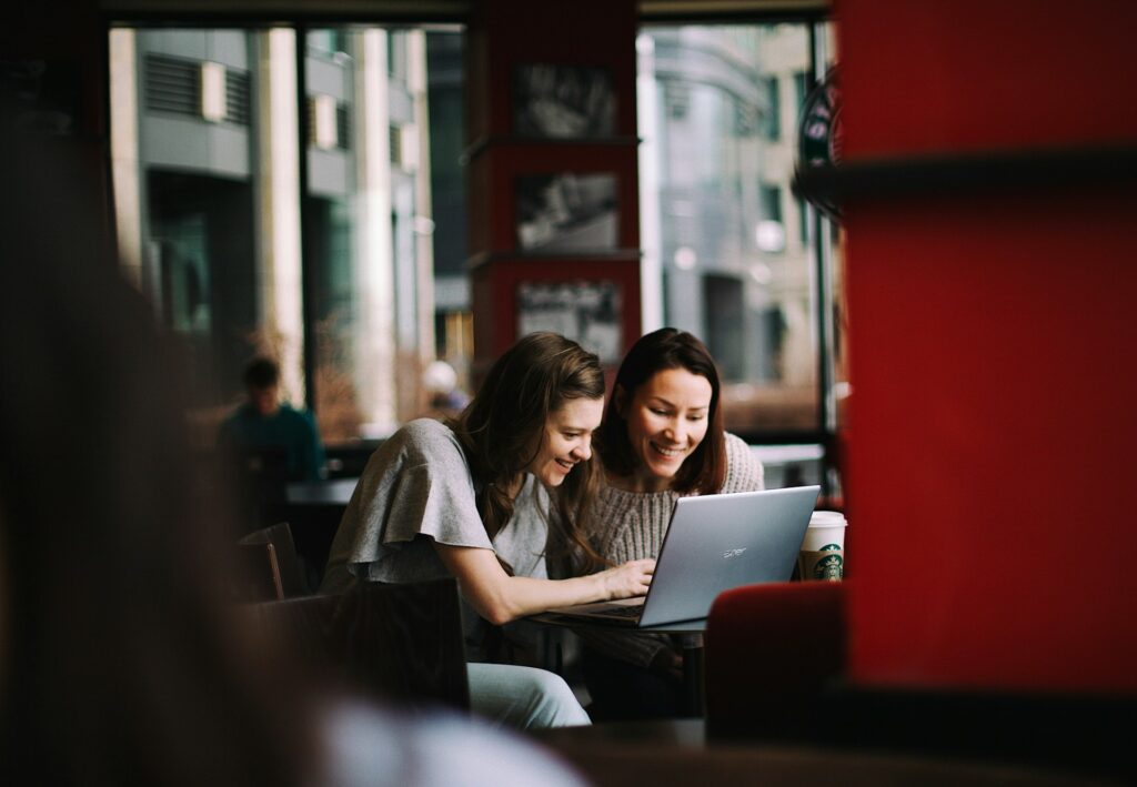 Speaking well together over a computer in a coffee shop.