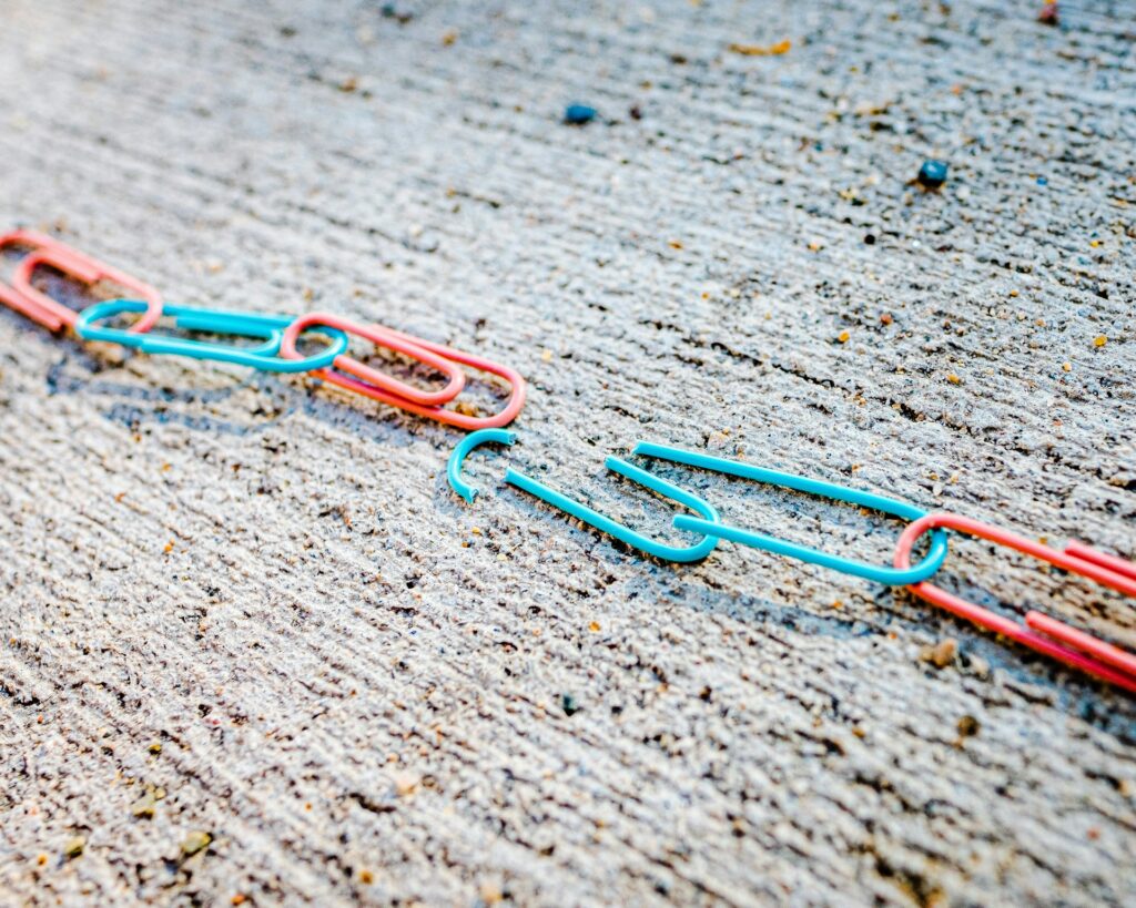 A chain of paper clips. With two broken links, meaning a communication breakdown