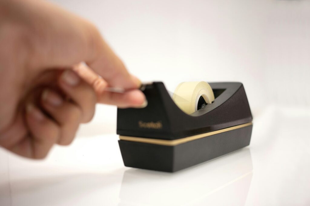 A Person Using a Tape Dispenser